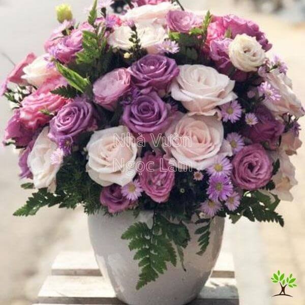 Rose arrangement in a tall vase shaped like a dome or hemisphere