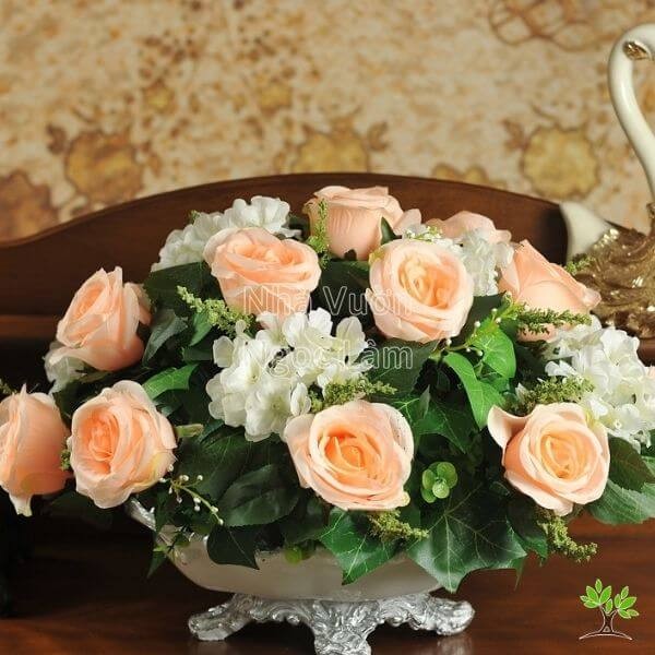 Rose arrangement in a tall vase shaped like an oval