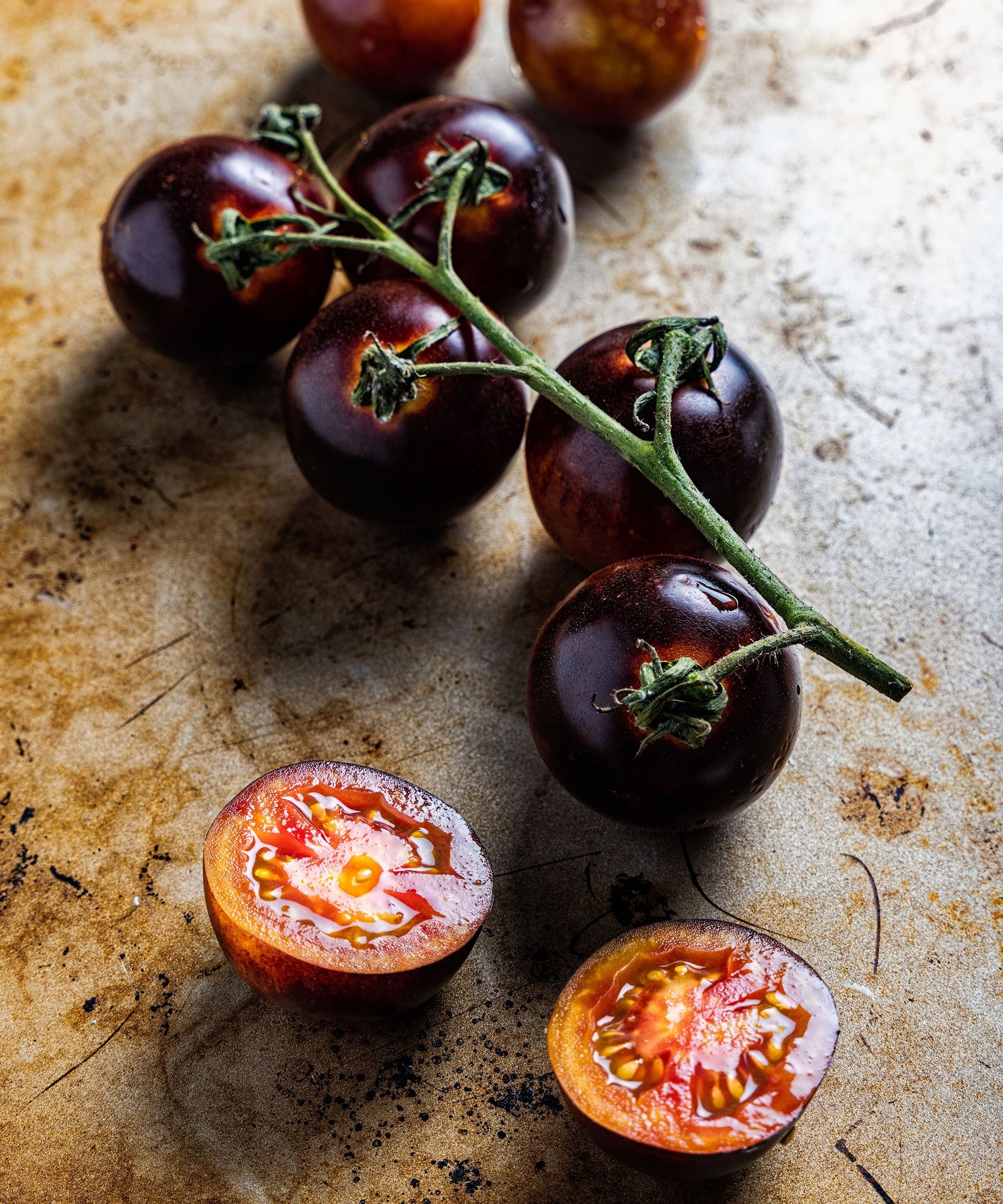 Sliced Black Cherry tomatoes showing deep color and texture