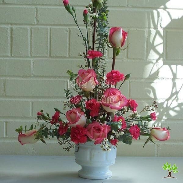 Tall vertical rose arrangement with sparse greenery